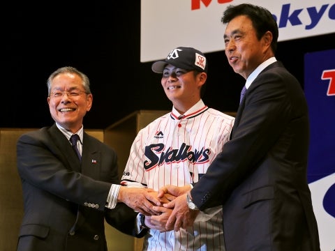 ユニホームに袖を通す